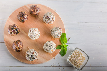 vegetarian food, energy balls of walnuts, dates, prunes, cranberries, honey with sesame