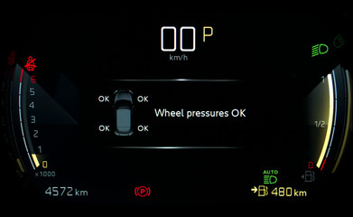 TPMS (Tyre Pressure Monitoring System) monitoring display on car dashboard panel. Checking tires...