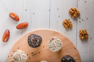 vegetarian food, energy balls of walnuts, dates, prunes, cranberries, honey with sesame
