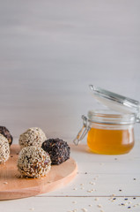 vegetarian food, energy balls of walnuts, dates, prunes, cranberries, honey with sesame