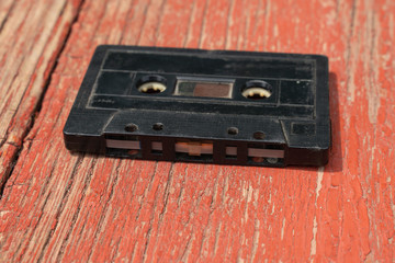 old black film audio cassette on a wooden table