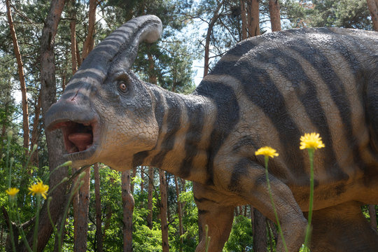 Realistic model of a Parasaurolophus against cloudy sky background. Dinosaur park in Belgorod , Russia - MAY 18, 2018