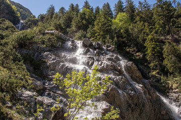 Fototapeta na wymiar View from a wild waterfall in the swiss alps