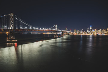 Fototapeta na wymiar Panoramic beautiful scenic view of the Oakland Bay Bridge and the San Francisco city in the evening, California