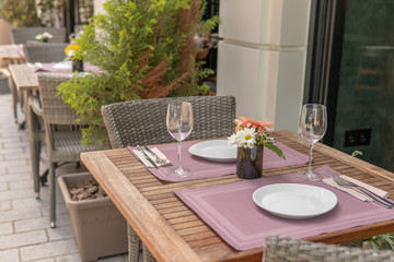 Fancy set table with flowers outside hotel