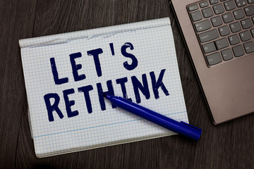 Conceptual hand writing showing Let s is Rethink. Business photo text an Afterthought To Remember Reconsider Reevaluate Open notebook squared page black marker computer wooden background