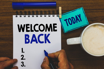 Conceptual hand writing showing Welcome Back. Business photo text Warm Greetings Arrived Repeat Gladly Accepted Pleased Man holding marker notebook clothepin reminder wooden table coffee