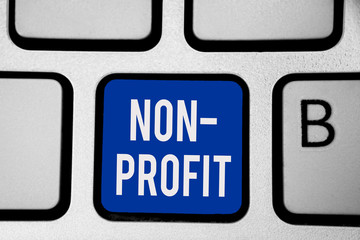 Word writing text Non Profit. Business concept for providing products or service without paying back in return Keyboard blue key Intention create computer computing reflection document
