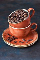 Natural background with coffee beans in ceramic mug
