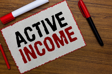 Text sign showing Active Income. Conceptual photo Royalties Salaries Pensions Financial Investments Tips White paper red borders markers wooden background communicating ideas