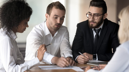 Diverse employees group working on project, discussing business strategy