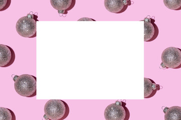 Pattern made of silver balls on pink background.