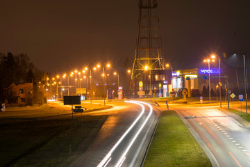 beautiful and mysterious city night landscape blurry and misty outline, car lights, fog, Latvia