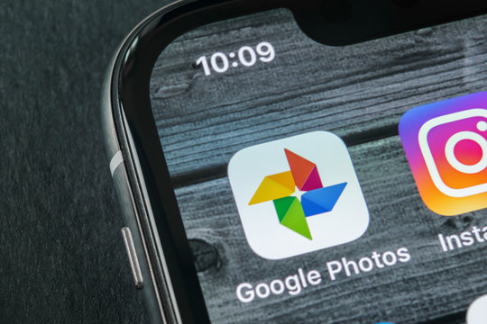 Sankt-Petersburg, Russia, April 11, 2018: Google Photos plus application icon on Apple iPhone X screen close-up. Google plus Photos icon. Google photos application. Social media network