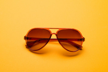 Stylish plastic dark sunglasses on colorful background. Eye care and diseases concept, eye...