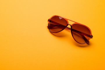 Stylish plastic dark sunglasses on colorful background. Eye care and diseases concept, eye...