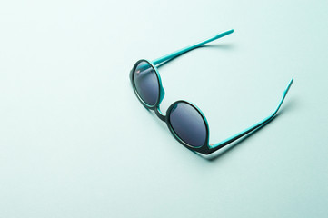 Stylish plastic dark sunglasses on colorful background. Eye care and diseases concept, eye...
