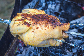 Cooking chicken on the grill. Chicken with delicious crispy peel while grilling_