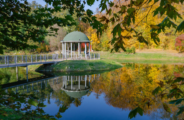 beautiful arbor on a pond, sunny autumn afternoon