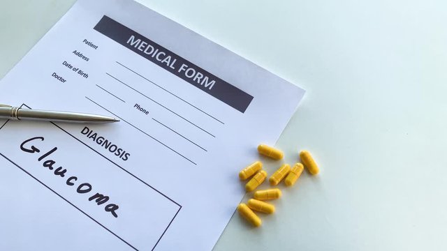 Diagnosis glaucoma in a medical form on the doctor desk