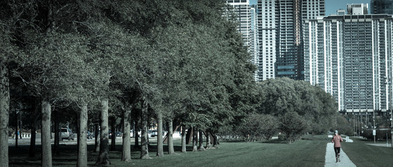 Urban park in downtown Chicago with fitness lady running