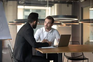 Colleagues working on project together, discussing business strategy