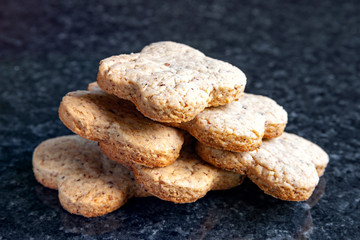 Fototapeta na wymiar Nuts cookies. Walnut cookies lie on a dark marble table.
