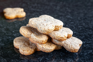 Nuts stack cookies. Walnut cookies lie on a dark marble table.