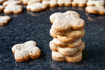 Nuts cookies. A close-up of a stack of walnut cookies lies on a dark marble table.