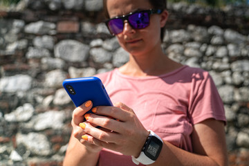 Fototapeta premium Woman holding smartphone with blank screen. 