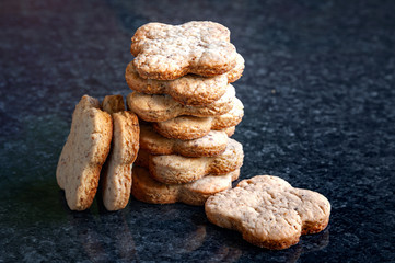 Fototapeta na wymiar Nuts cookies a lot. A close-up of a stack of walnut cookies lies on a dark marble table.