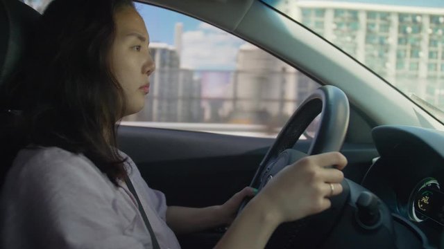 Asian woman driving a car
