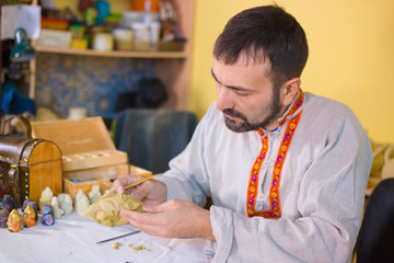 Potter making clay figure for board game