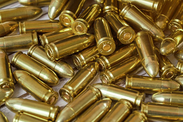 Heap of yellow brass gun bullets closeup