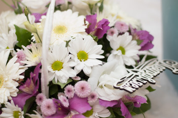 a bouquet of flowers with a wooden inscription