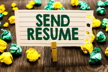Fototapeta premium Text sign showing Send Resume. Conceptual photo brief account persons education qualifications and occupations Clothespin holding notebook paper crumpled papers several tries mistakes