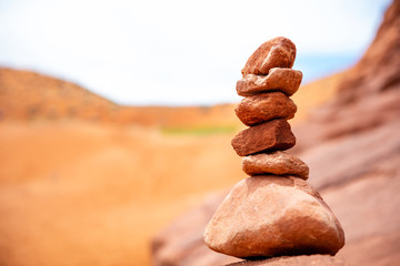 Zen stones stack, blur red desert background Arizona, US.
