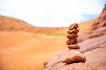Zen stones stack, blur red desert background Arizona, US.
