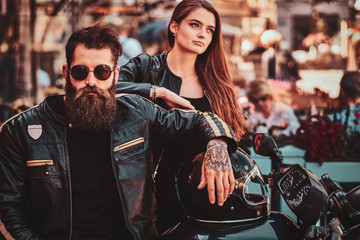 Beautiful couple with brutal biker and his sexy gilfriend are chilling near cefeteria with...