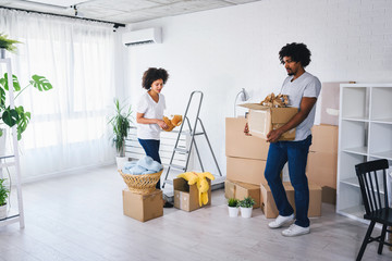 Young African-american Family Unpacking and Cleaning. Move into New Home.