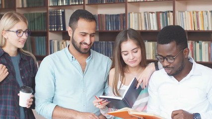 Multiracial students having fun in library while preparing for exams. Education learning Concept.