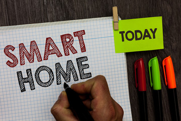 Conceptual hand writing showing Smart Home. Business photo text automation system control lighting climate entertainment systems Man holding marker notebook clothespin markers wooden table