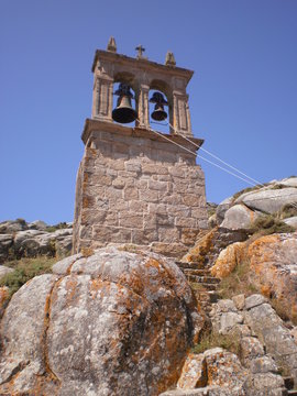 Picturesque bell tower of the parish of Santa Maria in Muxia. August 7, 2012. Muxia La Coruna Galicia, Spain. Vacation Nature Street Photography.