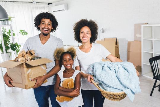 Young African-american Family Unpacking and Cleaning. Move into New Home.