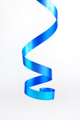 Blue wavy ribbon on white background. Vertical view