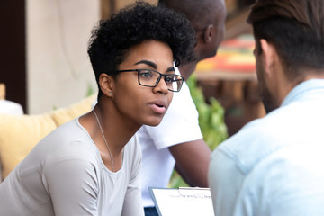 Worried millennial black woman talk with doctor sharing problems