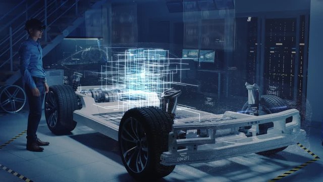 Engineer Wearing Augmented Reality Headset Chooses Body for New Electric Car Concept. 3D Graphics Visualization Shows Vehicle Frame Developing in Real Time into Futuristic Concept