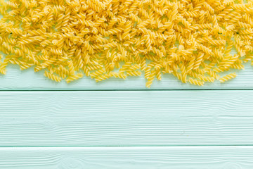 Italian pasta on mint green wooden table background top view mock up