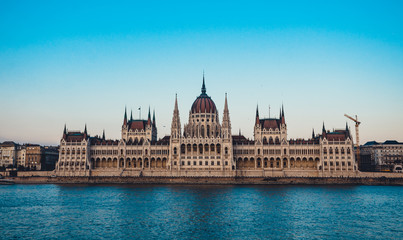 Fototapeta na wymiar Budapest parliament on the Danube at the daytime. Blue clear sky. Tourist destination. Natural colours