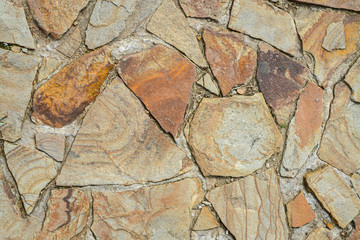 Texture of large flat stones. Abstract natural background. The concept of masonry made from natural, unprocessed stones.